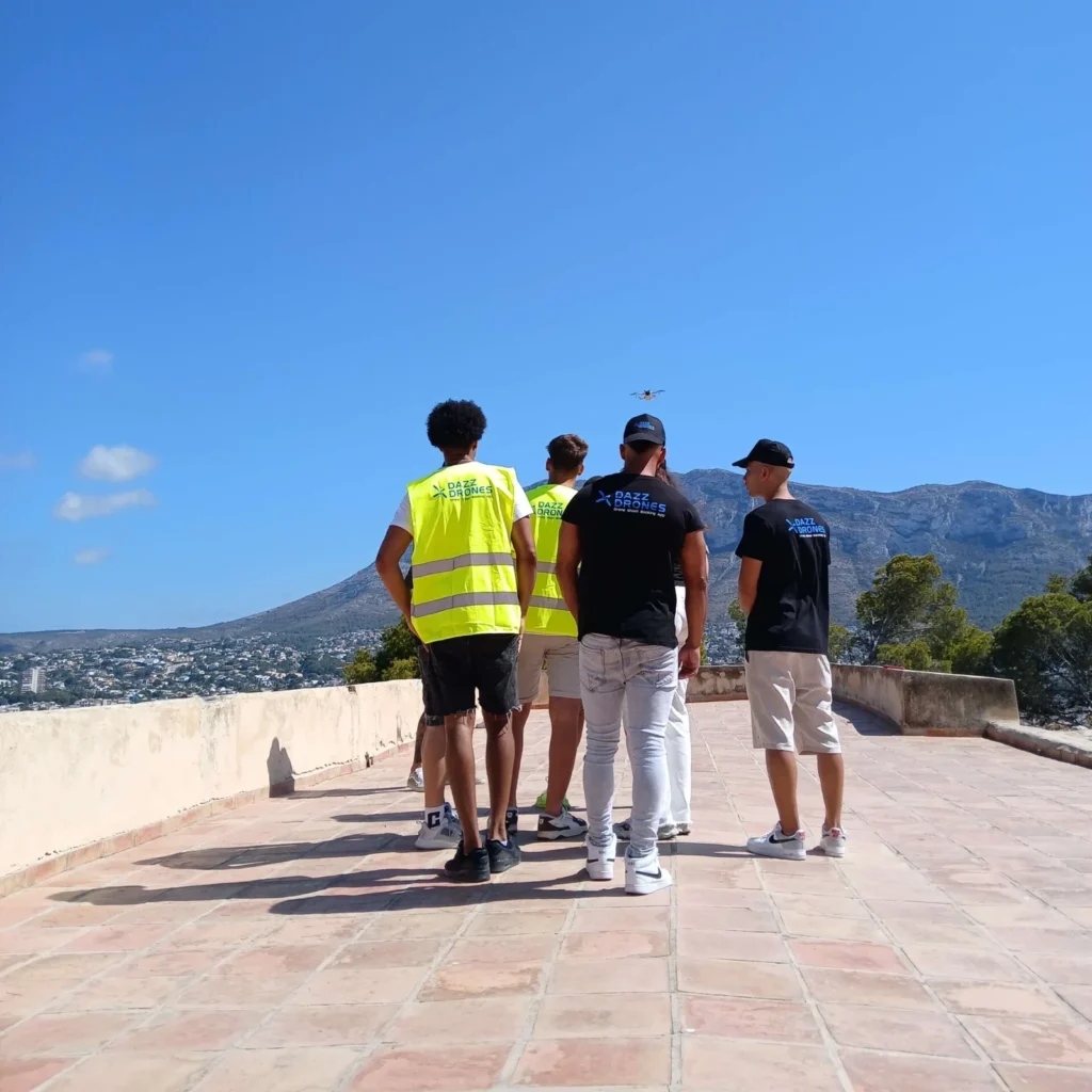 Drone pilots photographing beachfront resort at sunrise