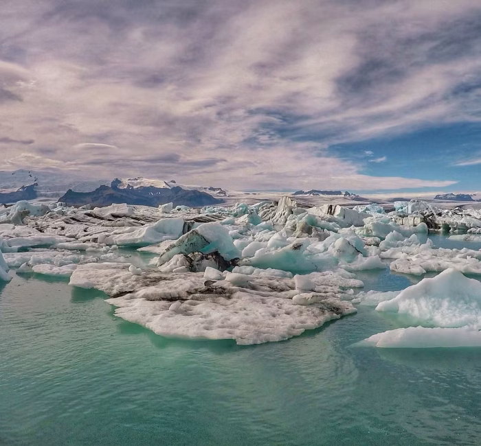 The Majestic Jökulsárlón Glacier Lagoon, Iceland Wide landscape view of Jökulsárlón glacier lagoon, South Iceland, filled with various sized icebergs calved from a nearby glacier, under a dramatic sky.