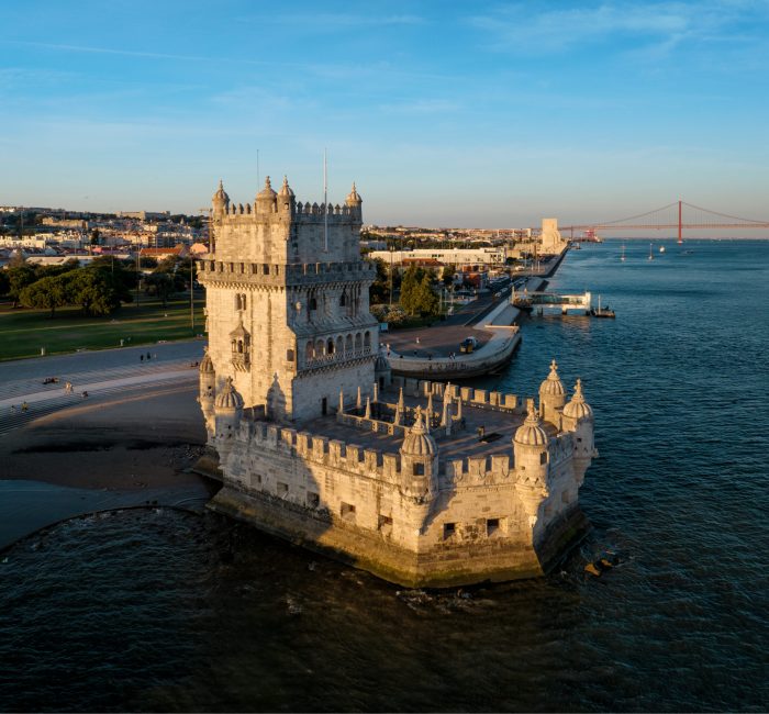 Belem Tower on the bank of the Tagus River at sunset. Lisbon, Portugal Aerial view of Belem Tower famous tourist landmark of Lisboa and tourism attraction on the bank of the Tagus River (Tejo) with tourist boats at sunset. Lisbon, Portugal