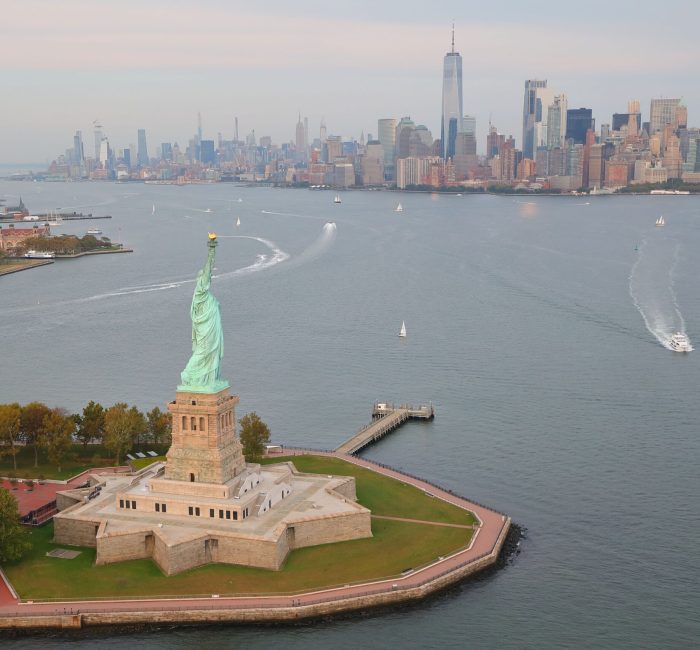 Drone view of the Statue of Liberty on Liberty Island in New York Harbor, New York City, USA A drone view of the Statue of Liberty on Liberty Island surrounded by water at sunset in New York Harbor, New York City, USA