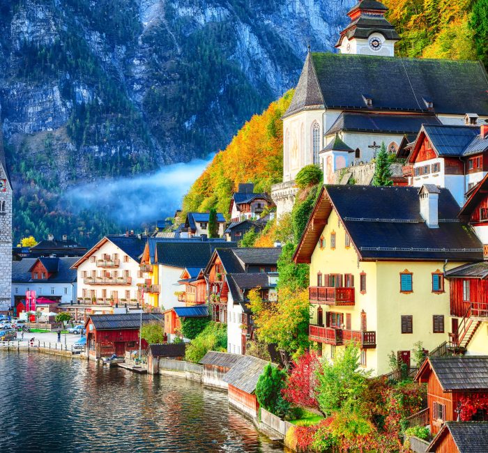 Foggy autumnal sunrise at famous Hallstatt lakeside town reflect Foggy autumnal sunrise at famous Hallstatt lakeside town reflecting in Hallstattersee lake. Location: resort village Hallstatt, Salzkammergut region, Austria, Alps. Europe.. Location: resort village Hallstatt, Salzkammergut region, Austria, Alps. Europe.