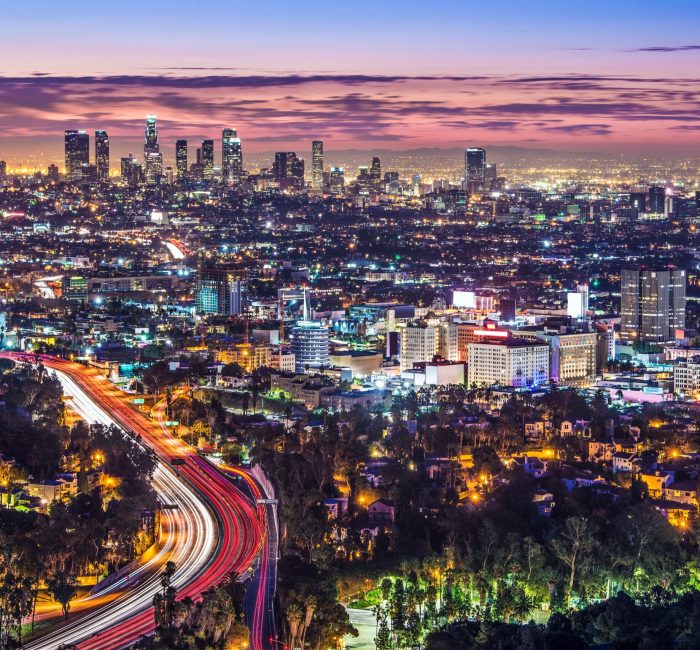Los Angeles city skyline at night A vibrant night view of Los Angeles city skyline with illuminated buildings and busy highways, showcasing urban life.